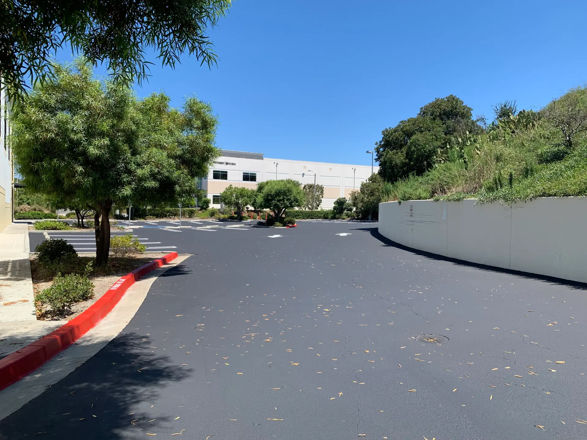 Fresh asphalt overlay on a retail parking lot by Native Union Engineering